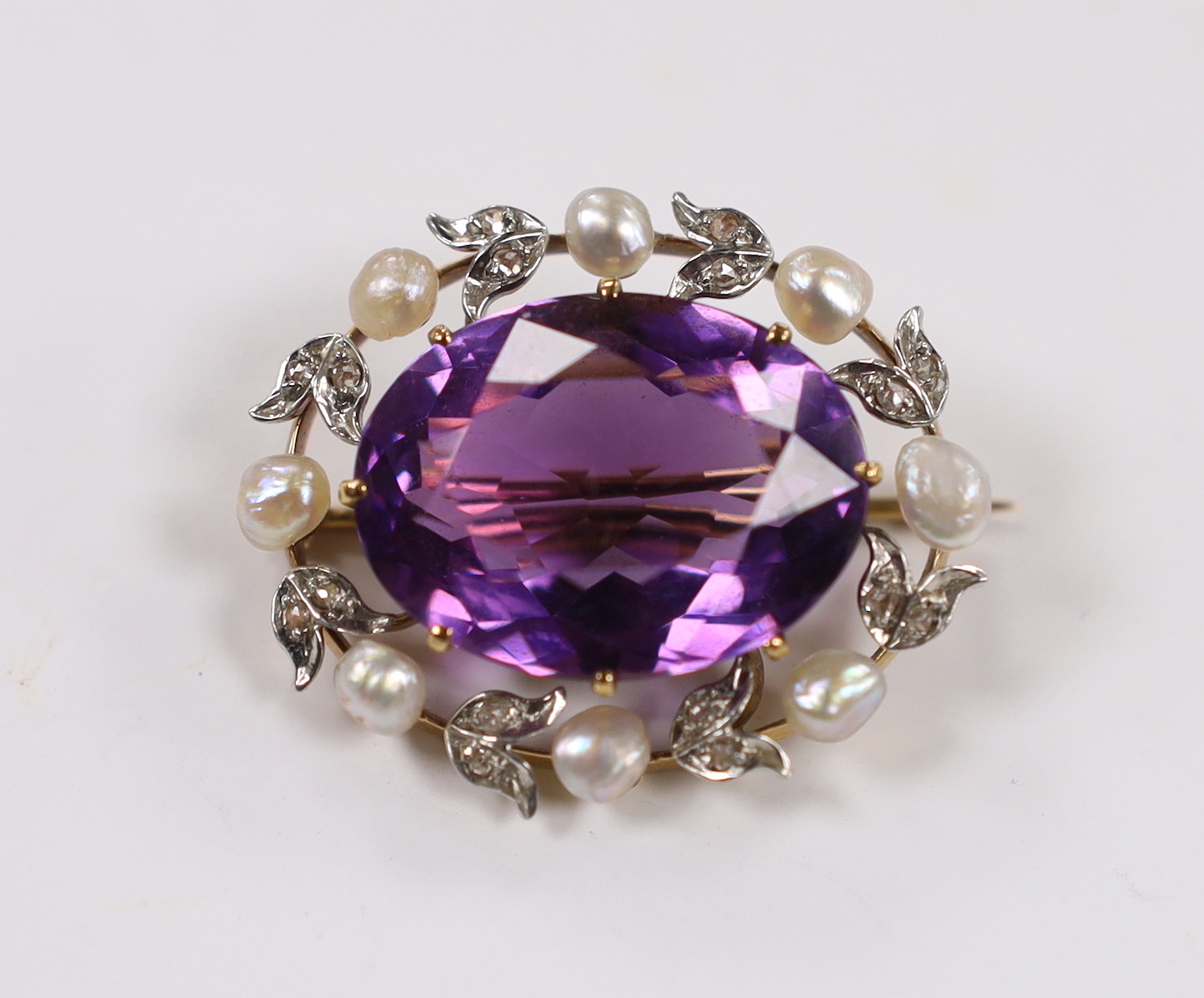 A yellow metal, amethyst, baroque pearl and diamond chip set oval brooch, 32mm, gross weight 11.4 grams.